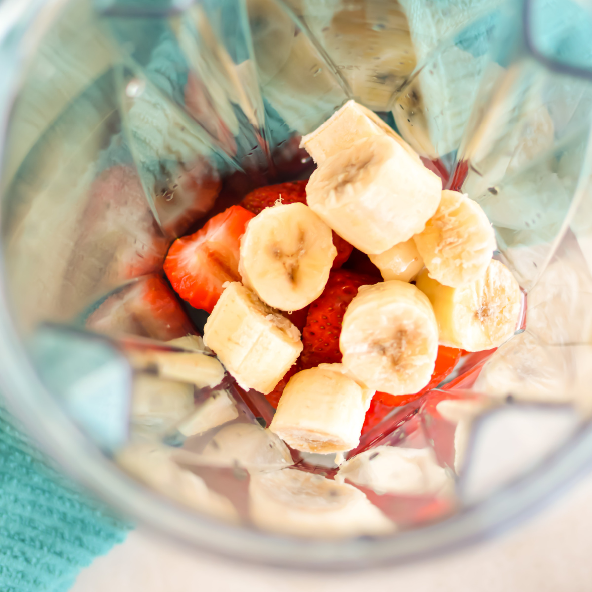 Strawberries and bananas in a blender.