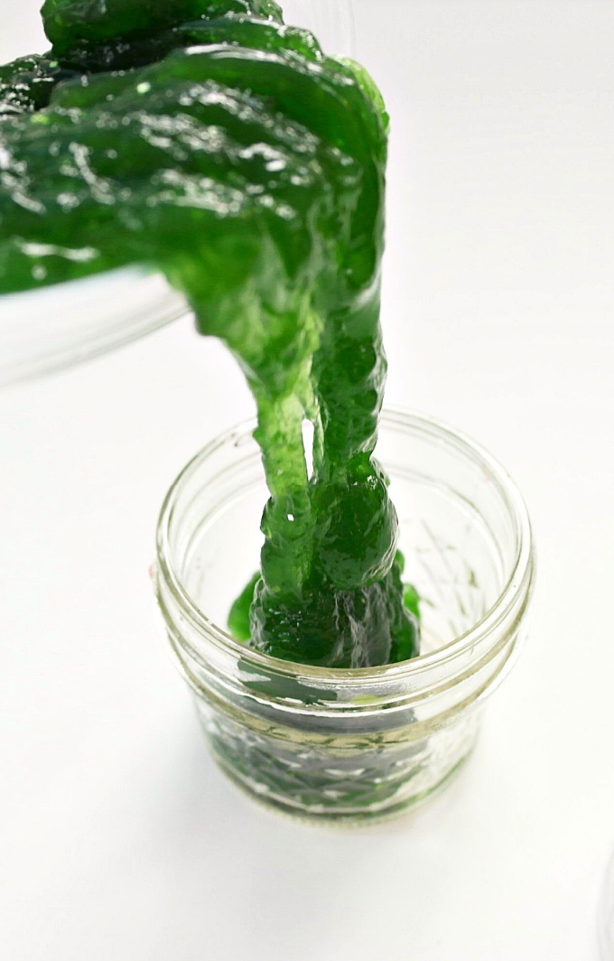 Oobleck 2-Ingredient Slime oozing from a bowl to a jar.