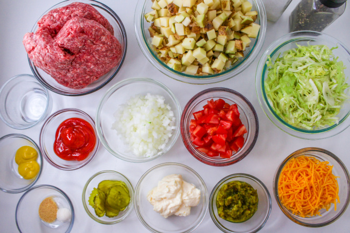 Big Mac Casserole Ingredients in bowls on a countertop.