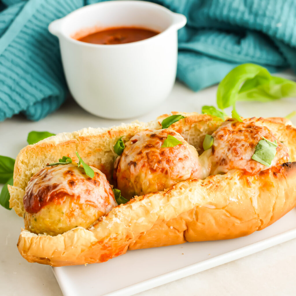 Close up of a Chicken Meatball Sub on a plate.