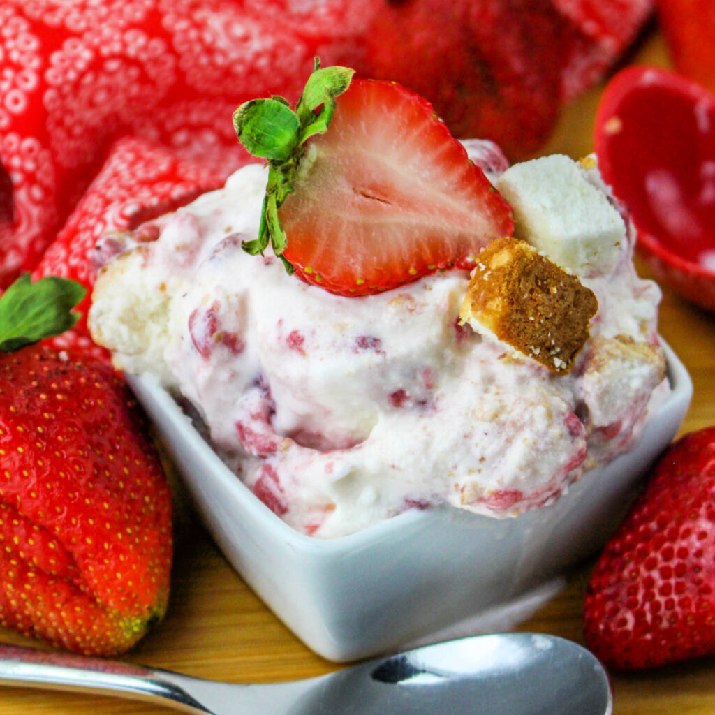 Strawberry Shortcake Ice Cream in a small square dish with a fresh strawberry.