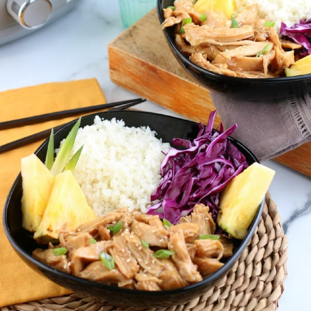Slow Cooker Teriyaki Chicken Recipe in bowls with rice, cabbage and pineapple.
