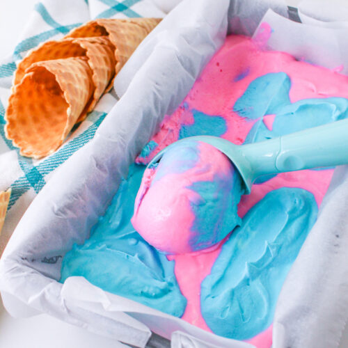 Cotton Candy Ice Cream in a container with an ice cream scoop.