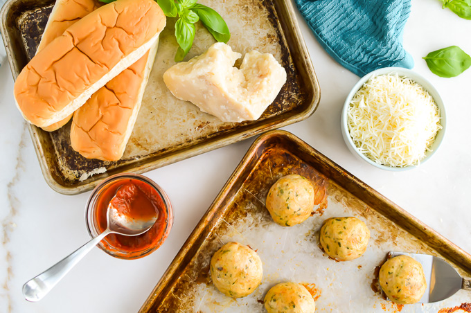Ingrdients to make Chicken Meatball Subs on trays.