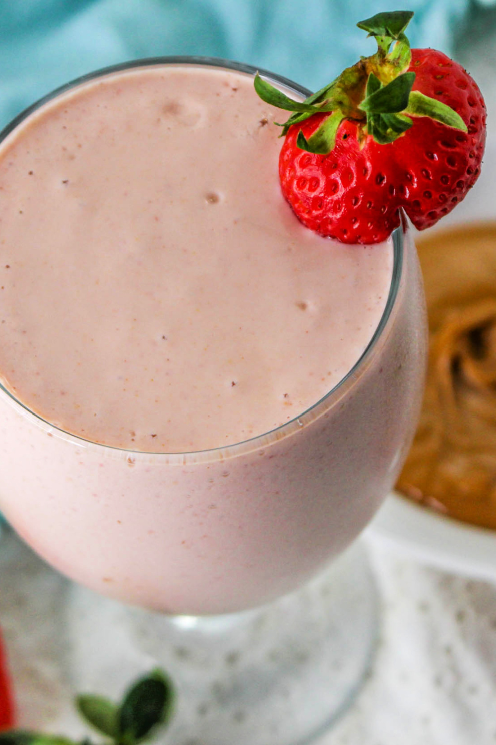 Peanut Butter and Jelly Smoothie garnished with a strawberry.