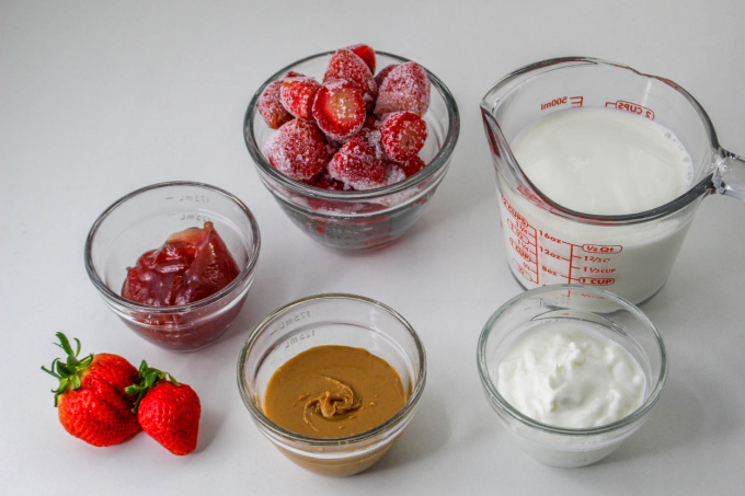 Peanut Butter and Jelly Smoothie Ingredients on a countertop.