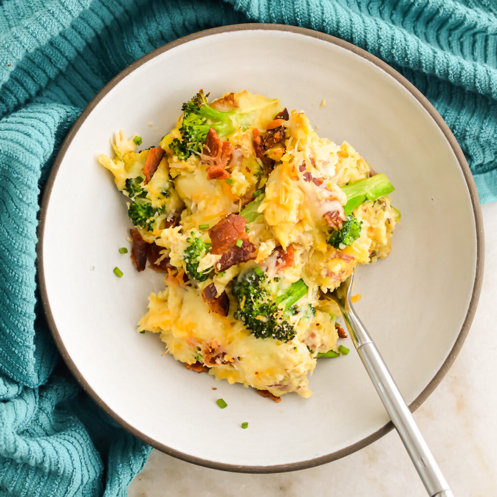 A bowl of Potato Chicken and Broccoli Casserole with a fork.