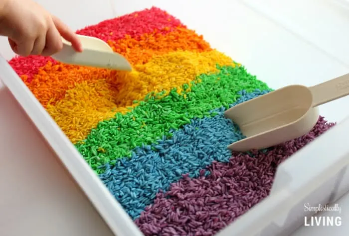Rainbow Rice Sensory Bin with scoops.