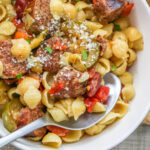 Slow Cooker Sausage Stew in a bowl with a spoon.