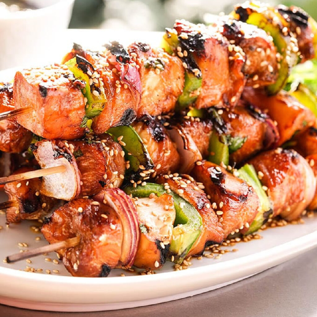 Pile of Teriyaki Chicken Skewers with peppers and onions.