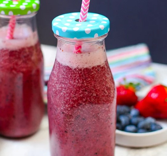 Berry Green Smoothie in a glass jar.