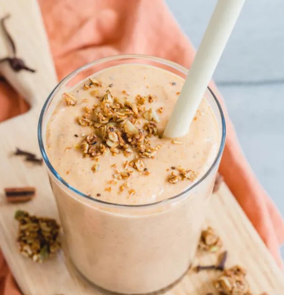 Butternut Squash Smoothie in a glass with a straw.