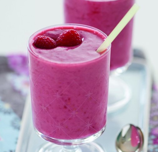 Raspberry Smoothie in a glass with a straw.