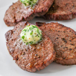 Air Fryer Steaks with Garlic Butter on a plate.