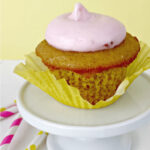 Banana Cupcake with strawberry mascarpone frosting on a small pedestal.