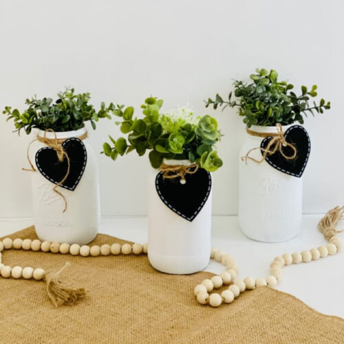 Chalk Paint Mason Jar Centerpieces on a table with a bead garland.