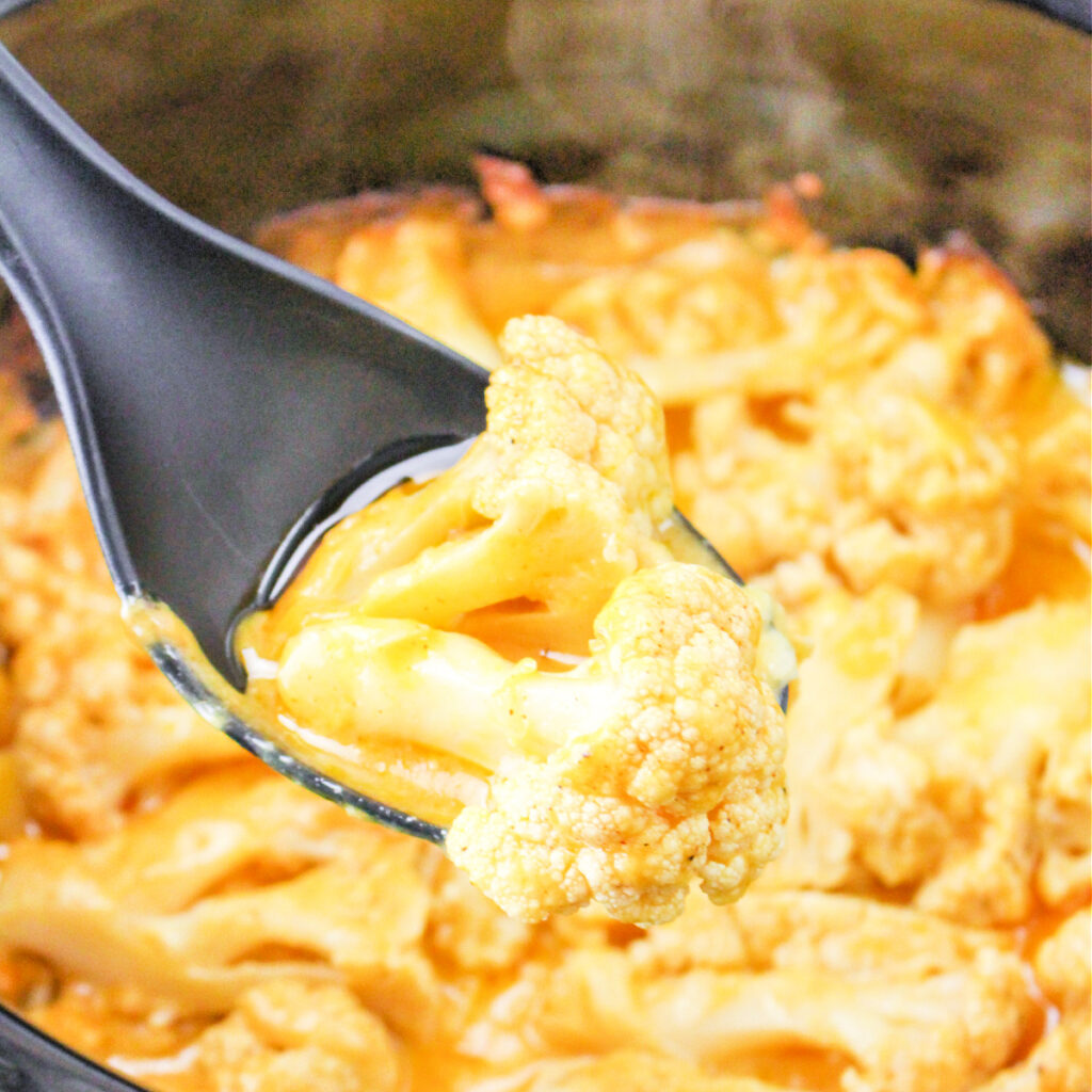 Close up of a spoonful of Crockpot Cheesy Cauliflower.