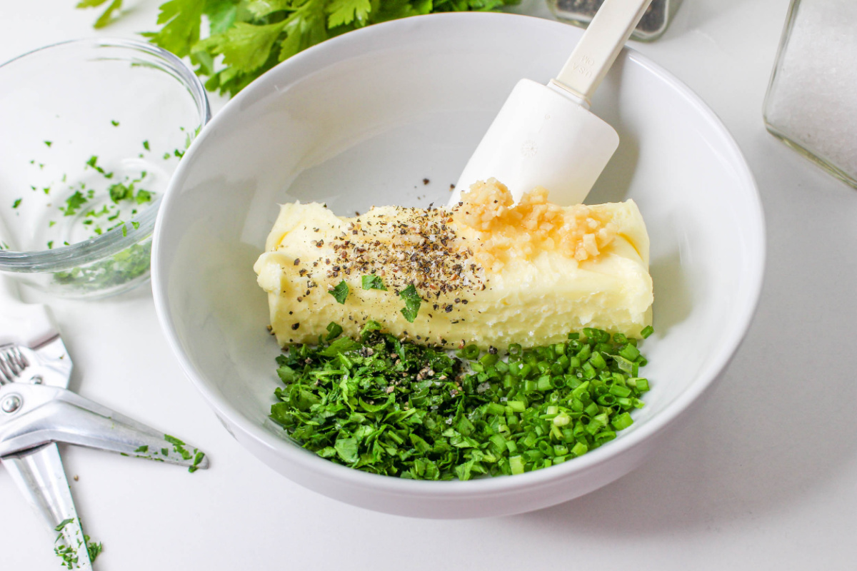 Ingredients for Garlic Butter in a white bowl.