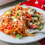 Greek Spaghetti Bake on a plate with a fork.