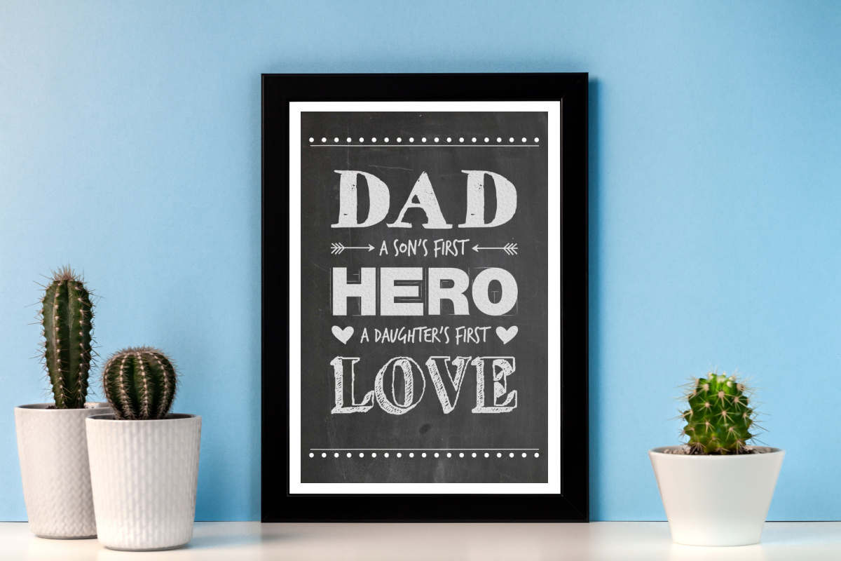 Framed Hero Dad Father's Day Printable and plants on a shelf.