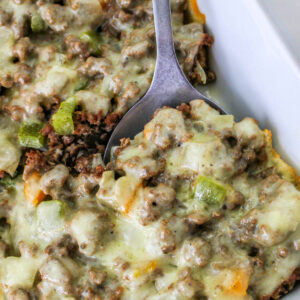 Close-up of Philly Cheesesteak Casserole with a serving spoon.