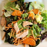 Mandarin Orange Salad with Chicken on white plate.