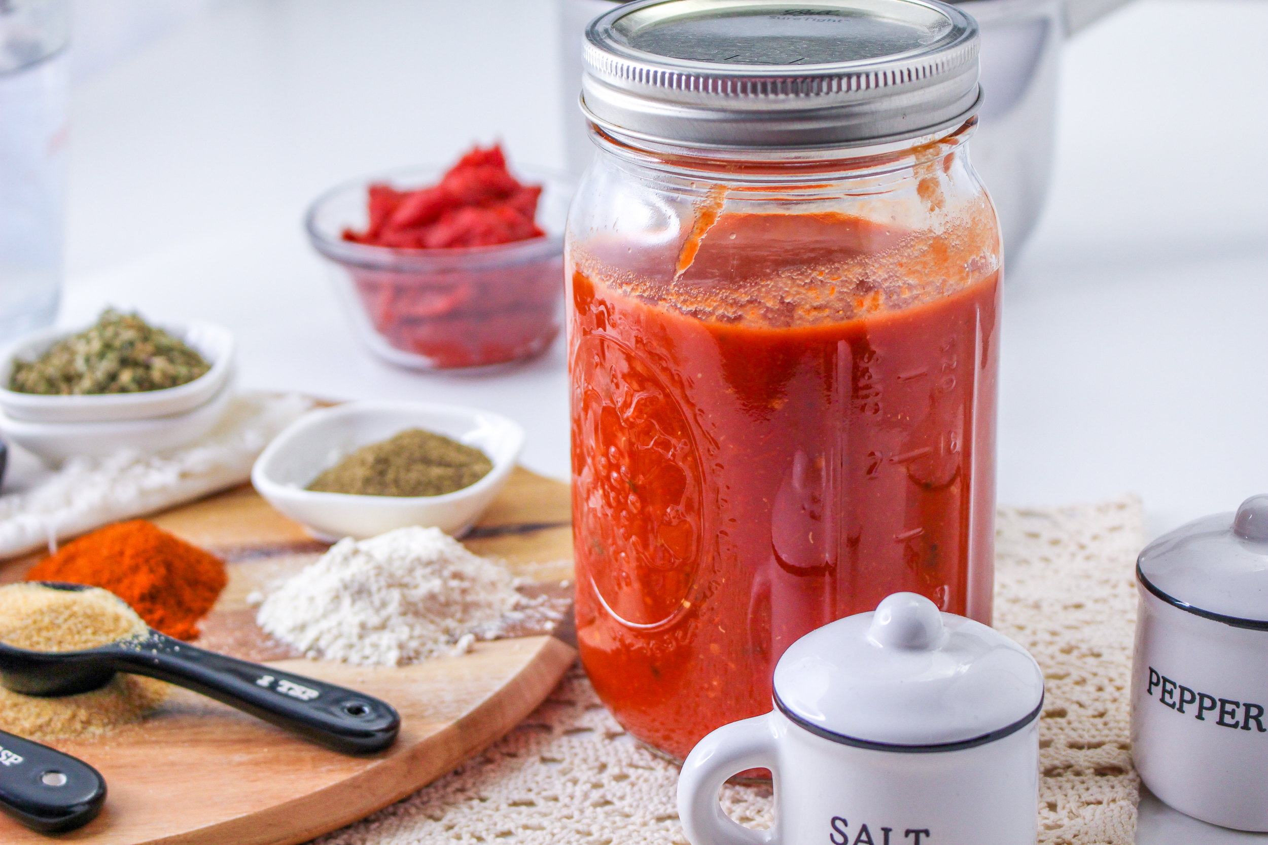 Mccormick Spaghetti Seasoning Mix ingredients with a jar of tomato sauce.