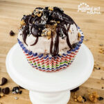 Ice Cream Cupcakes with fudge topping on a pedestal.