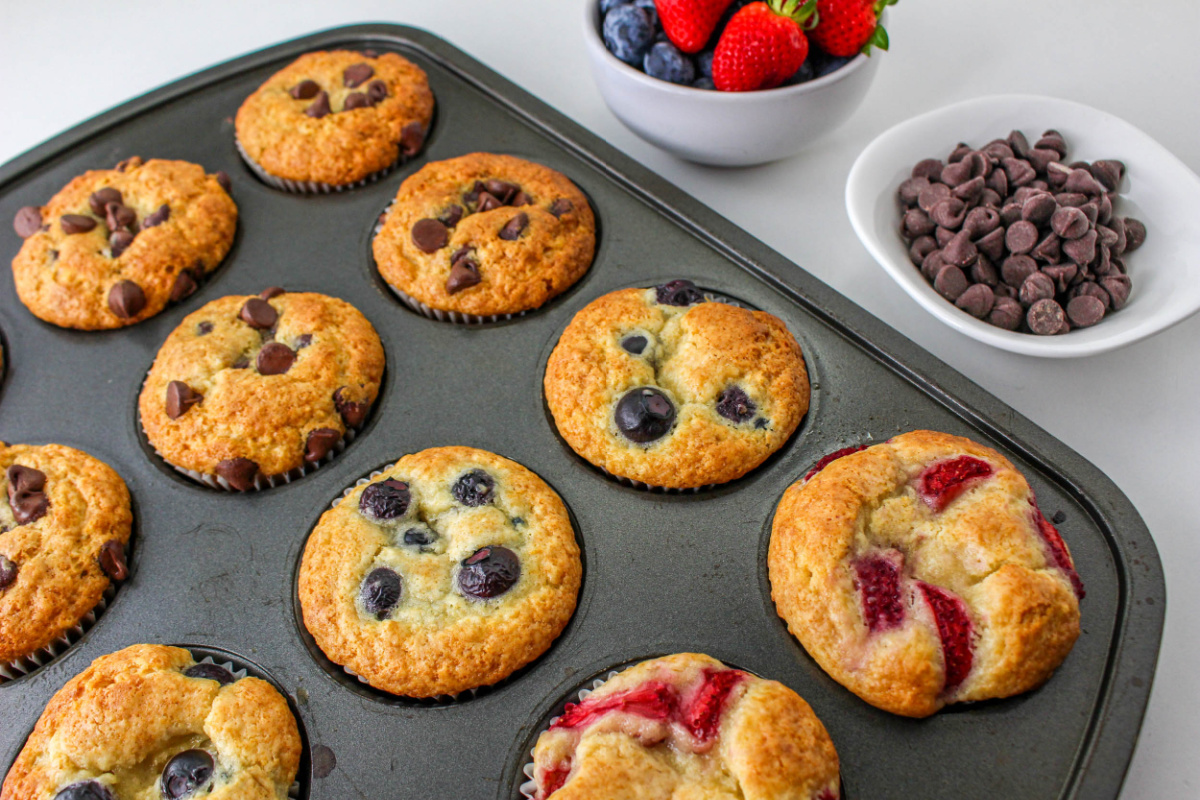Muffins made from Pancake Mix with fruit and chocolate in a baking pan.