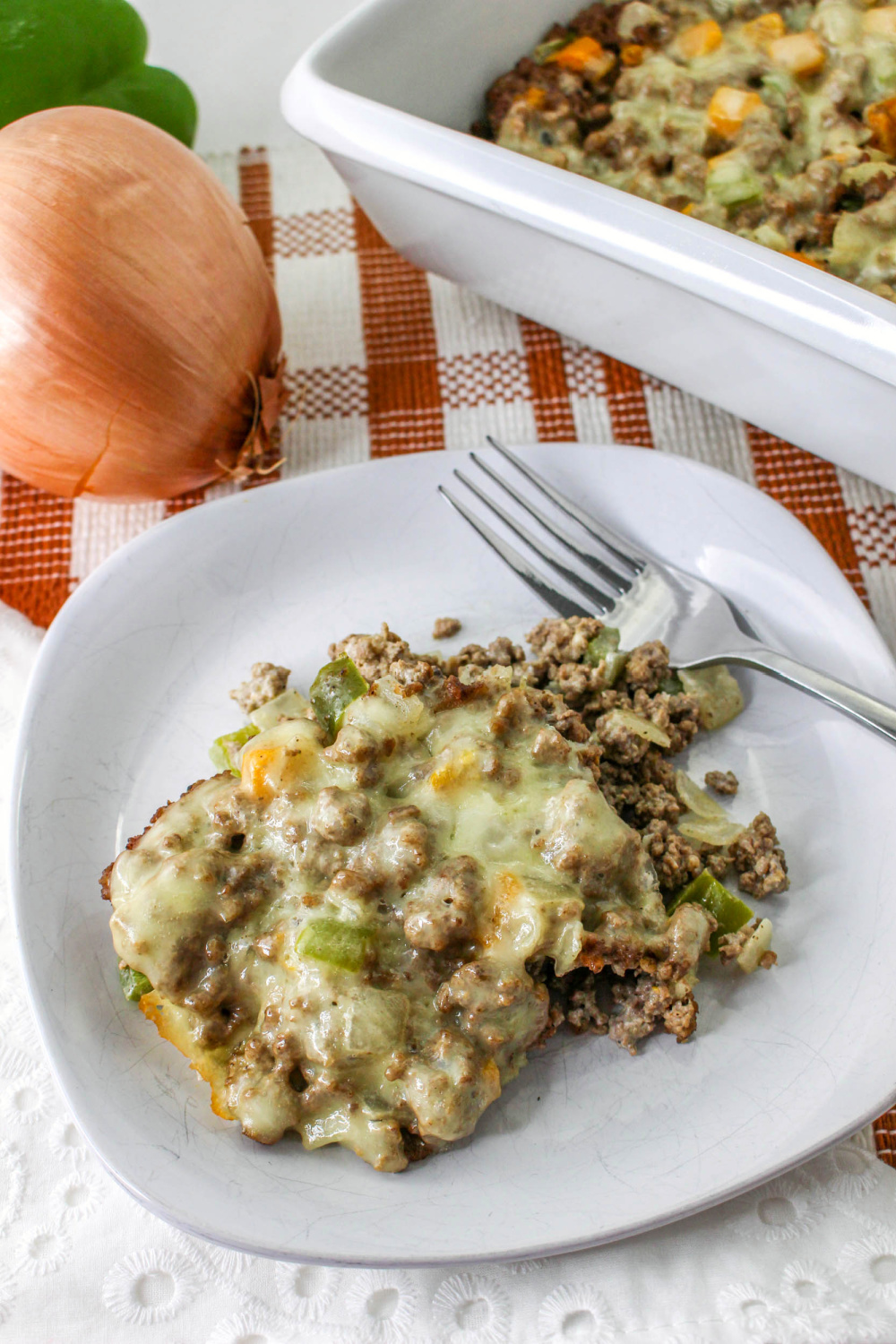 Philly Steak and Cheese Casserole on a white plate with a fork.
