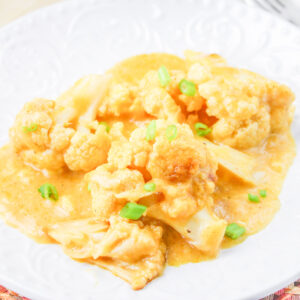 Crockpot Cauliflower on a white plate.