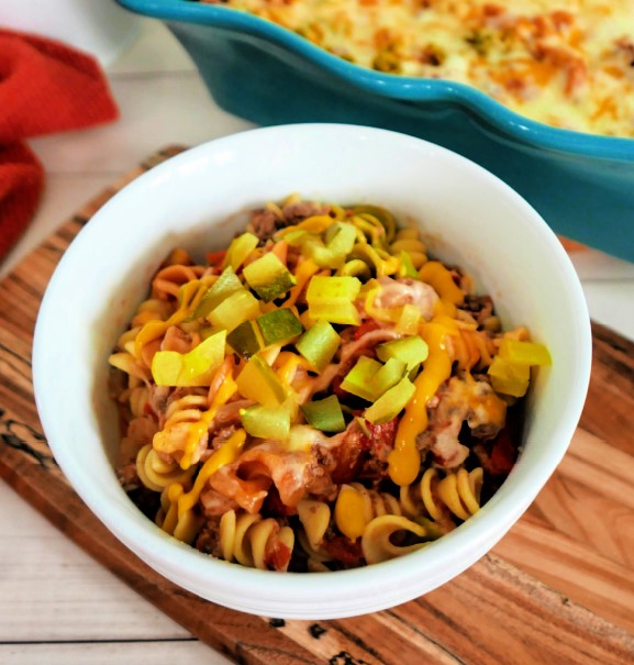 Cheeseburger Casserole with noodles and pickles in a bowl.