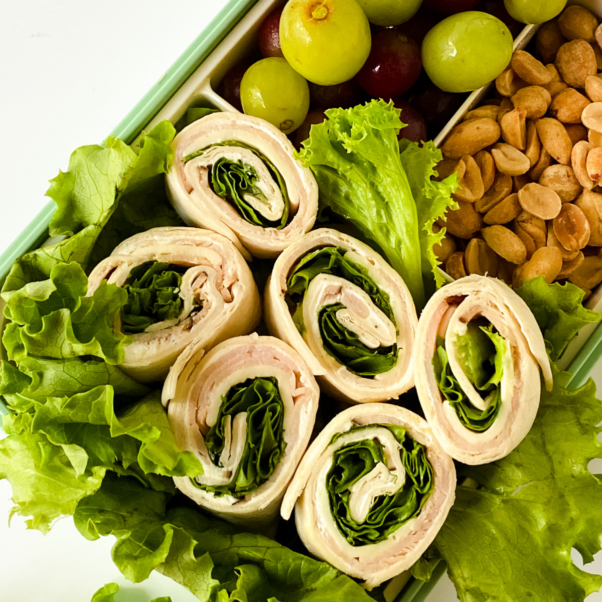 Turkey and Cheese Pinwheels in a lunch box.