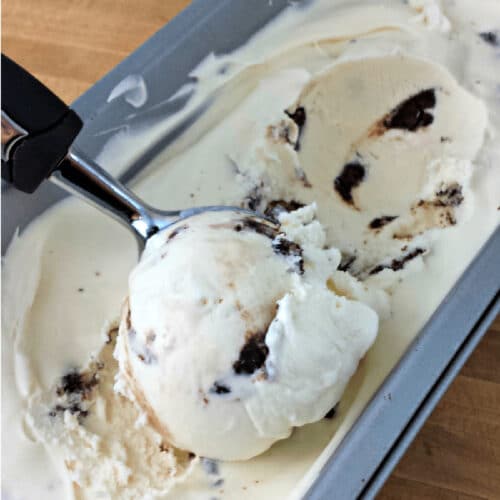 Brownie Bite Ice Cream being scooped out of a container.