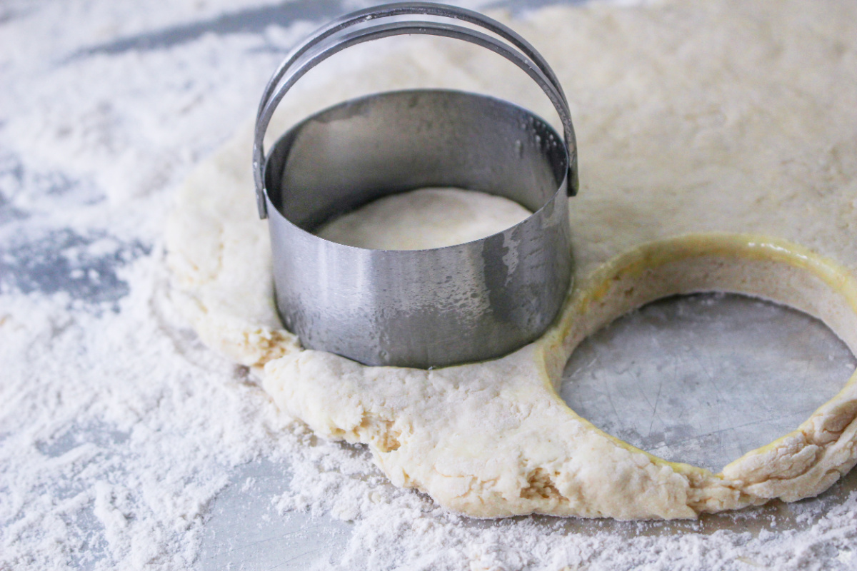 How to Make Sour Cream Biscuits: biscuit dough and a biscuit cutter.