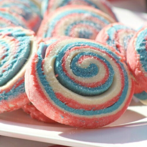 Close up of red, white, and blue Pinwheel Cookies on a platter.