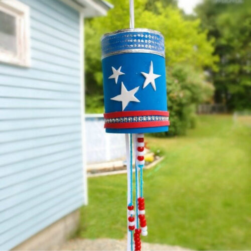 Red, white, and blue Patriotic Wind Chime children's craft hanging outside.