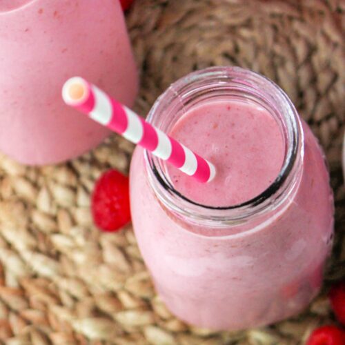 Bottle of Raspberry and Strawberry Smoothie with a straw.