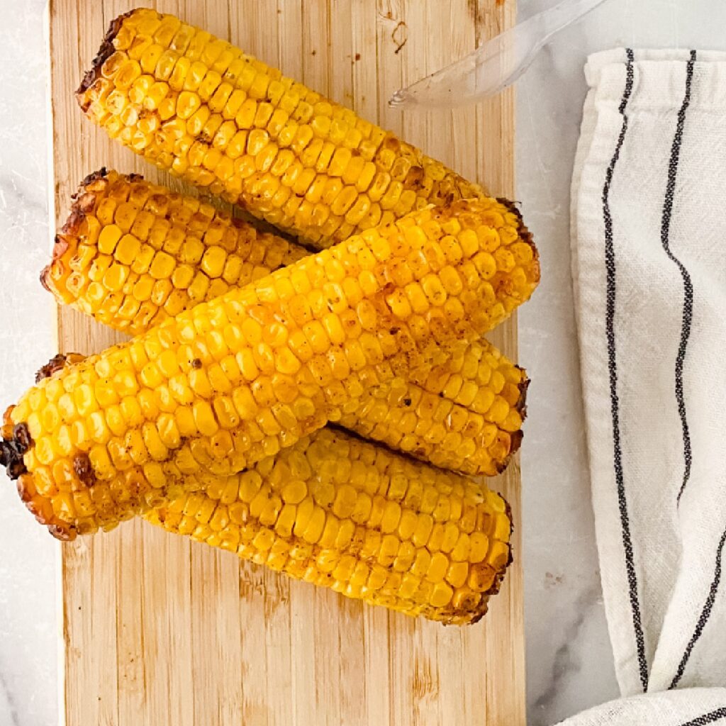 Air-Fried Corn on a cutting board.