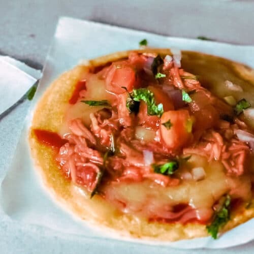 BBQ Chicken Tosados with onion, tomato, and cilantro.