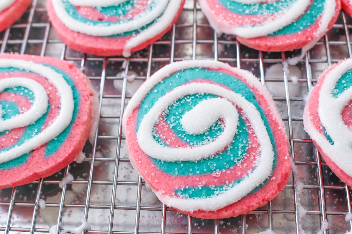 Frosted Cotton Candy Swirl Sugar Cookies on a cooling rack.
