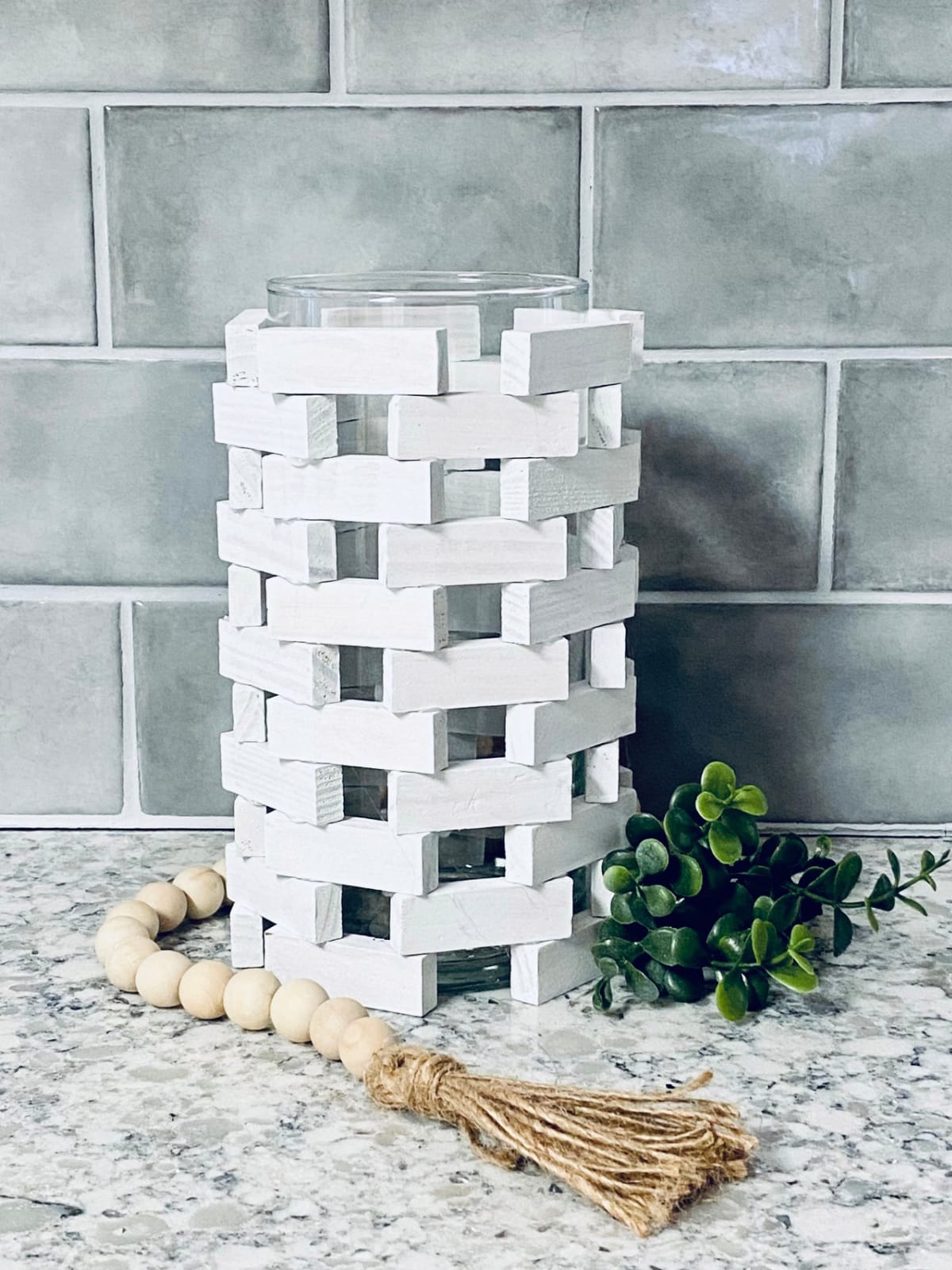 Dollar Tree Candle Holder on a countertop with wood beads.