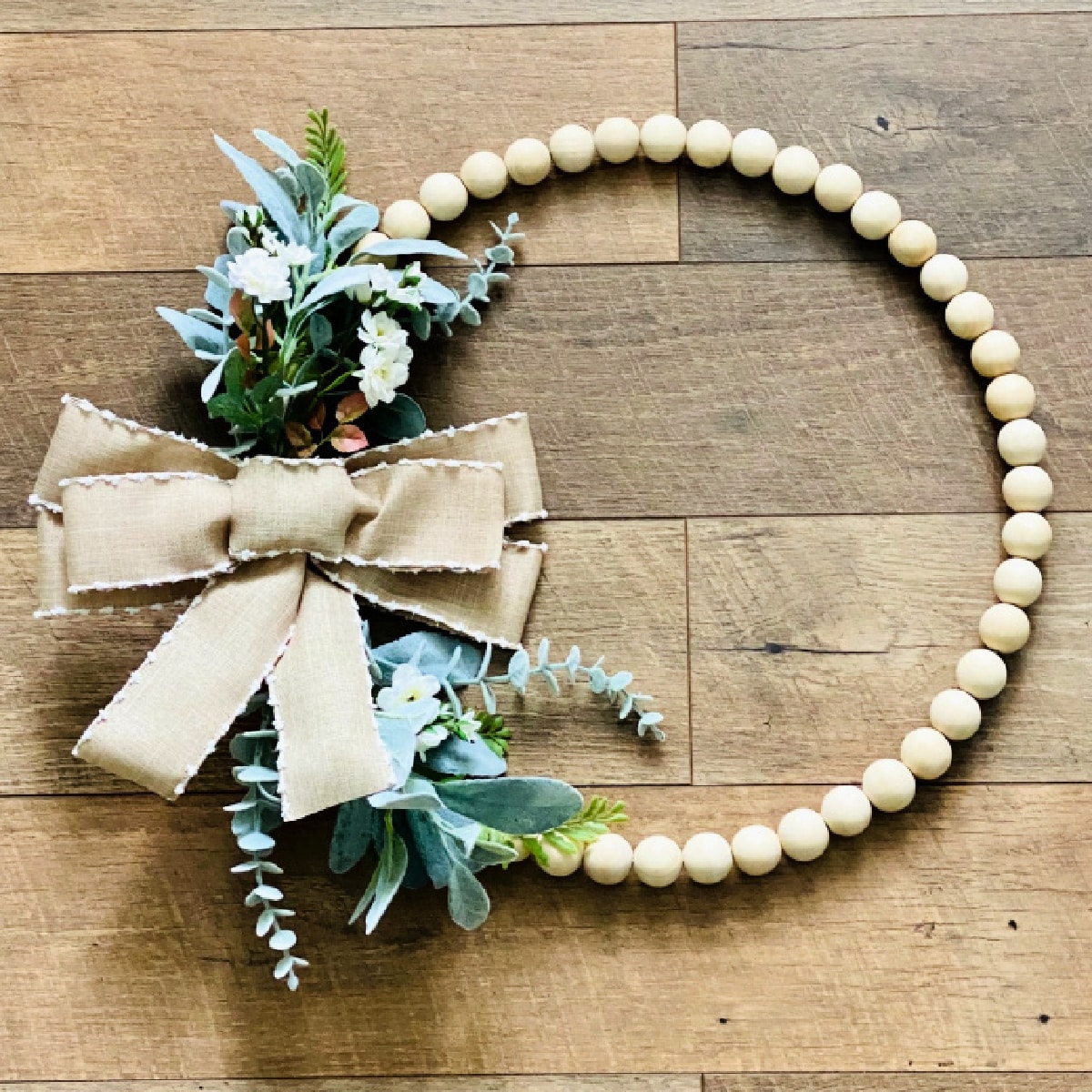Wood Bead Wreath on a wooden background.
