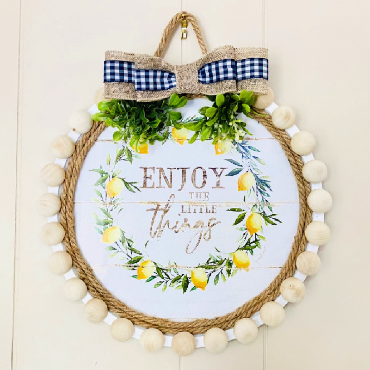Pizza Pan Wreath with burlap ribbon handing on a wall
