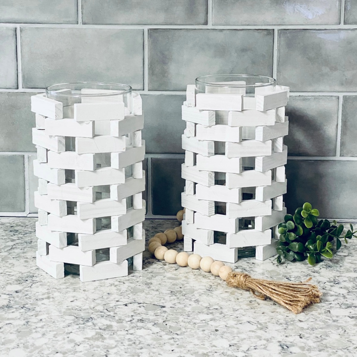 Wooden Block Candle Holders on a countertop with wood beads.