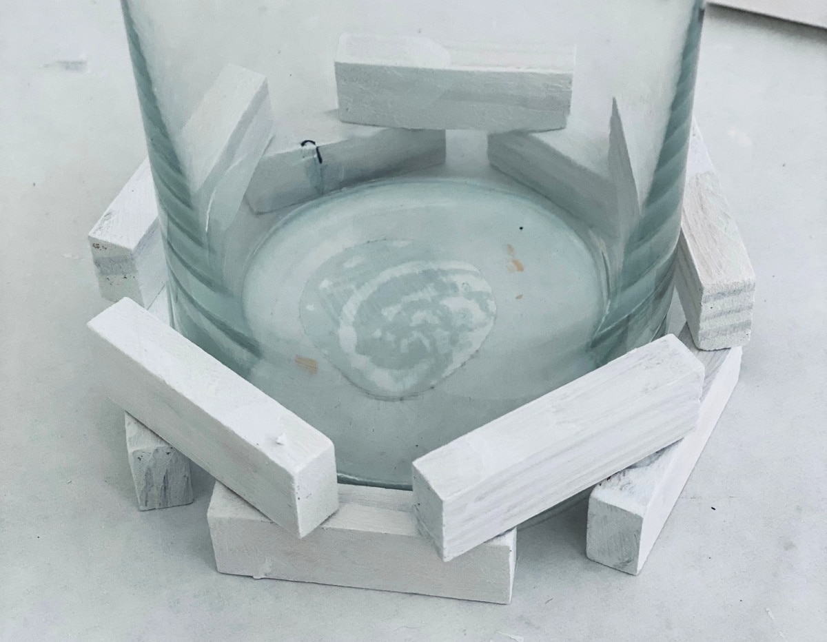 White wooden blocks glued to a vase.