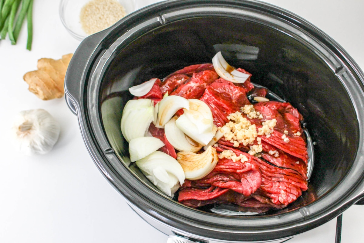 How to make Korean Beef in a slow cooker: ingredients in a crockpot.