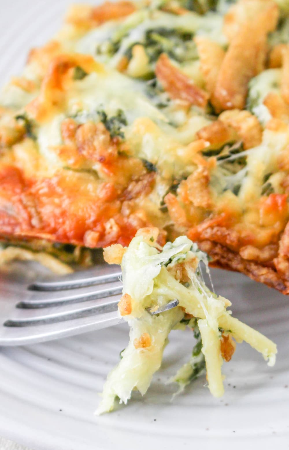 Close up of a bite of cheesy Monterey Spaghetti casserole.