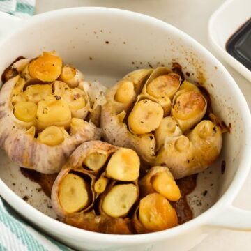 Roasted garlic in a small baking dish.