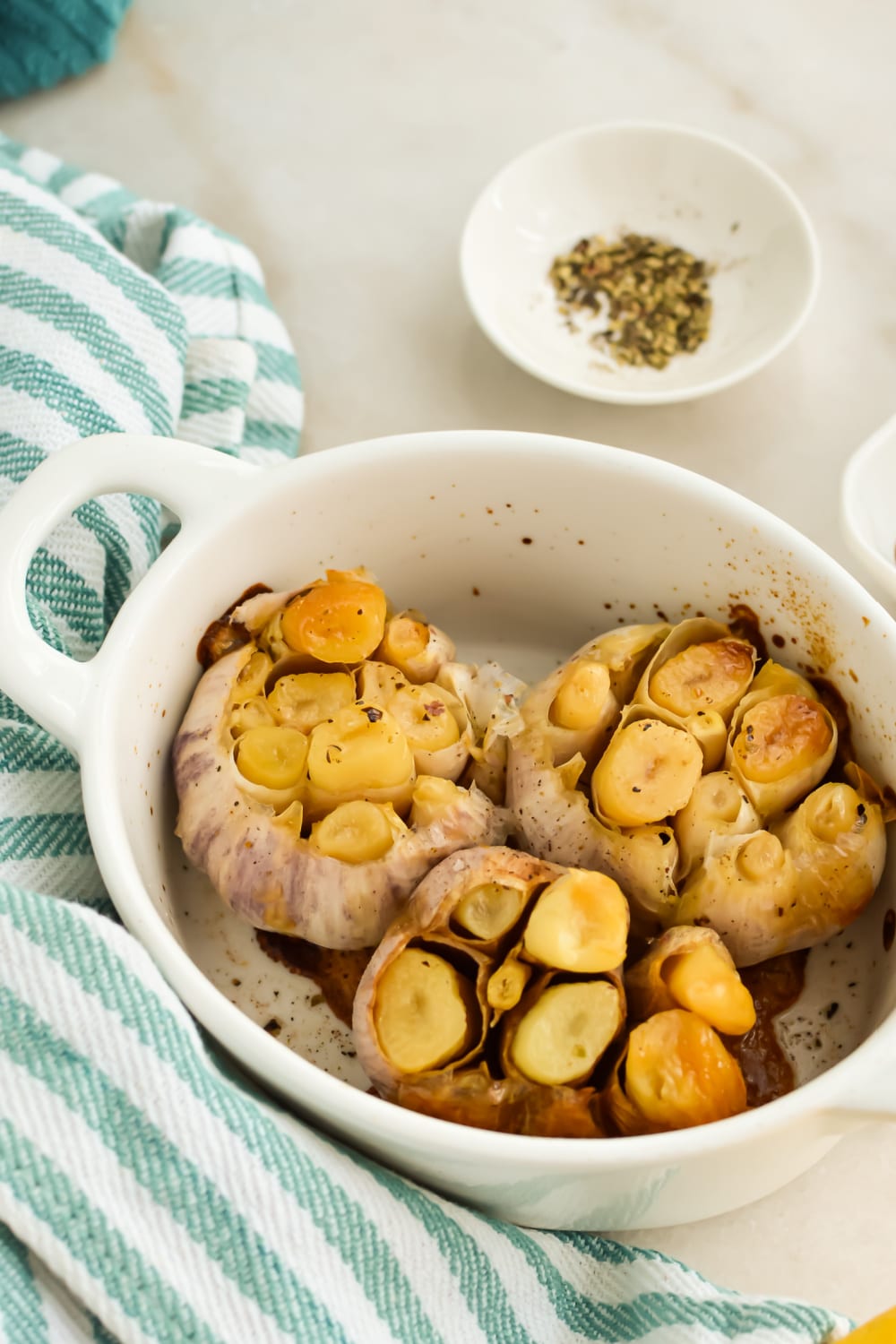 Roasted Garlic with Olive Oil in a baking dish.